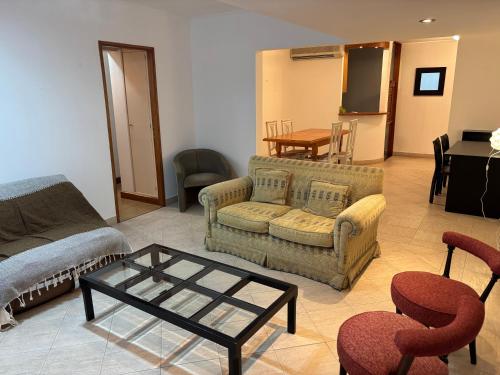a living room with a couch and a table and chairs at Departamento en Gualeguay in Gualeguay