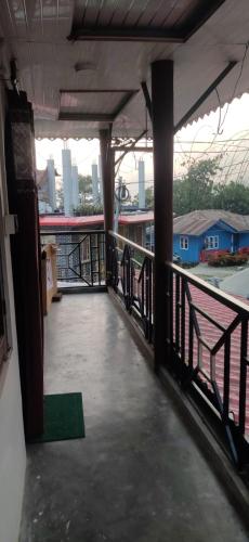 a balcony of a building with a view of the city at Mountain View Hillside Homestay Kalimpong, Between Silk Route- Deolo Park- Ramdhura in Kalimpong