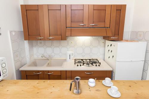 a kitchen with wooden cabinets and a counter top at Porto Rotondo Vacanze in Porto Rotondo