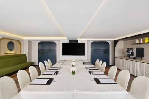 a large conference room with a long table and chairs at The Park Lane Hong Kong, Autograph Collection in Hong Kong