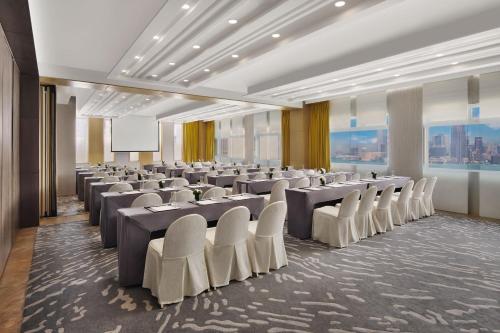 a conference room with rows of tables and chairs at The Park Lane Hong Kong, Autograph Collection in Hong Kong