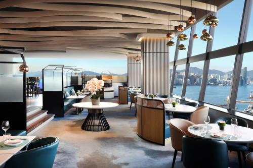 a restaurant with a view of the water at The Park Lane Hong Kong, Autograph Collection in Hong Kong