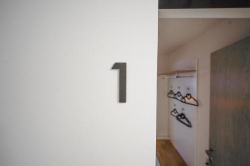 a number on a wall in a room with a refrigerator at Penzion Mona in Jeseník