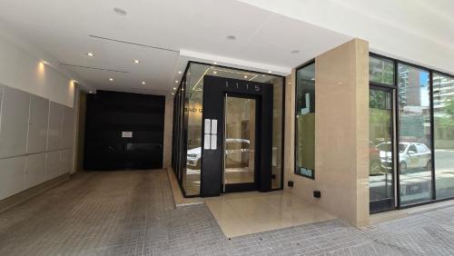 a hallway of a building with a revolving door at Monumento y Río - Parking privado con costo adicional in Rosario