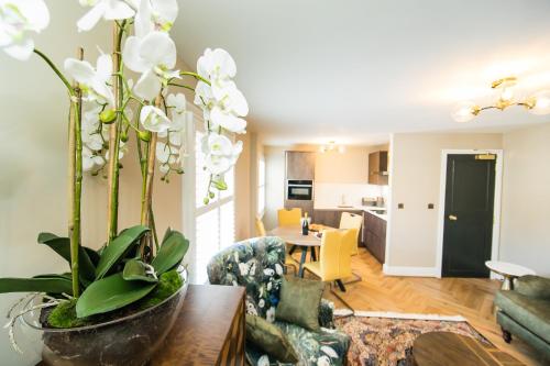 a living room with a couch and a table at Serenity Suites in Whitby