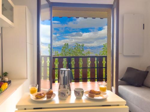 a table with food and orange juice on a balcony at Bleuets VI in Sainte-Léocadie