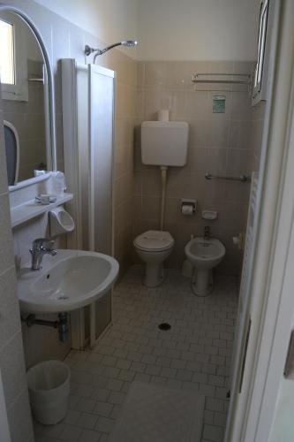 a bathroom with a sink and a toilet and a shower at Hotel Dei Platani in Rimini