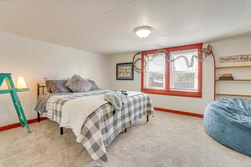 a bedroom with a bed and a window at Near Murphy River Walk Historic Downtown Home! in Murphy