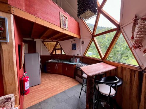an interior view of a kitchen in a tiny house at Domo Huepil in Pichare