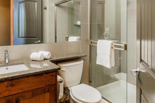 a bathroom with a toilet and a shower and a sink at Stoneridge Mountain Resort in Canmore