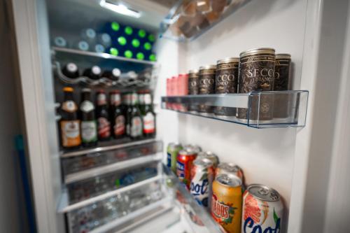 a refrigerator filled with lots of drinks and soda at Penzion Mona in Jeseník