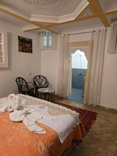 a bedroom with a bed with a view of the ocean at Dar Khmissa Fes-Luxury Stay Fes Medina in Fès