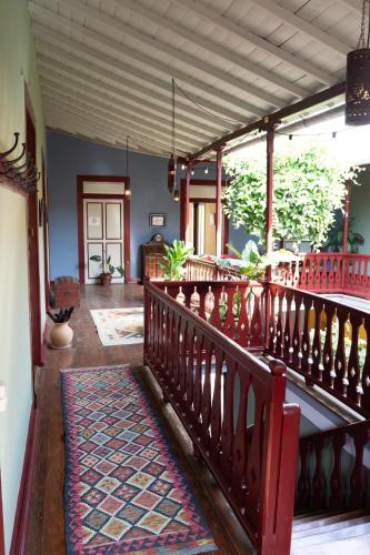 a room with a staircase with a rug on it at The Colonial Guest House in São Filipe