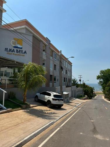 a white car parked in front of a building at Flat Novo Todo Climatizado em Alter do Chão in Alter do Chao