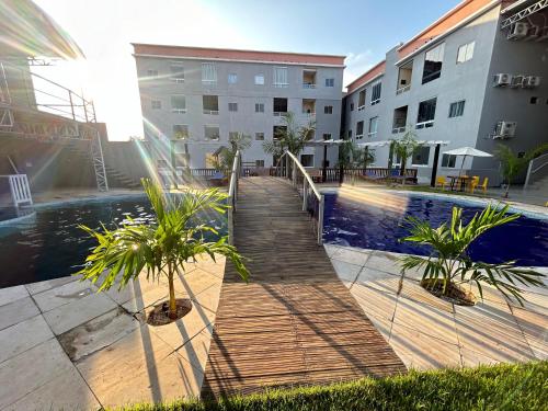 a boardwalk leading to a swimming pool in a building at Flat Novo Todo Climatizado em Alter do Chão in Alter do Chao