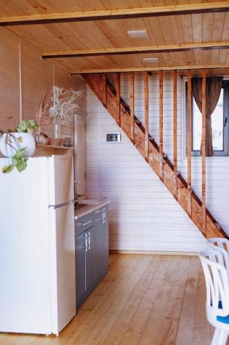 a kitchen with a white refrigerator and a staircase at IN CLOUDS RESORT Byurakan in Antarut