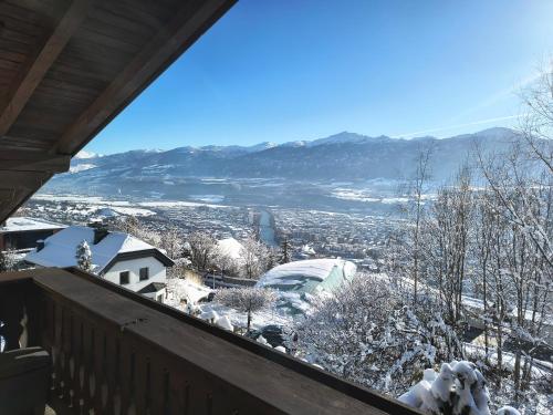 a view from the balcony of a house in the snow at Alpendohle Apartments Innsbruck in Innsbruck