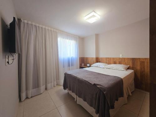 a bedroom with a large bed and a window at Luxor Paulo Miranda Cabo Branco by Hosppedar in João Pessoa