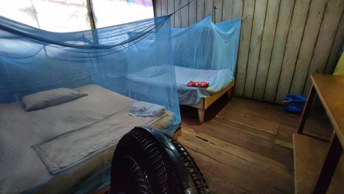 Cama o camas de una habitación en Hospedaje y tours Reina Arriera amazonas colombia