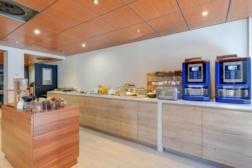a kitchen with a counter with aasteryasteryasteryasteryasteryasteryasteryasteryastery at Best Western Hotel Atrium Valence in Valence