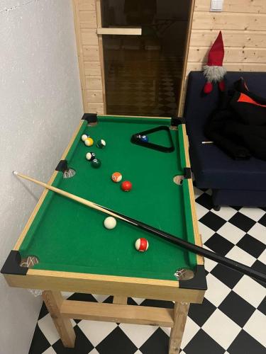 a pool table with billiard balls and cues on it at WIDOKOVO - Relax, cisza,widoki, sauna & jacuzzi wliczone w cenę in Laski