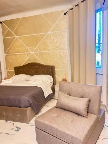 a bedroom with a bed and a chair and a couch at Infinity Passion in Rho