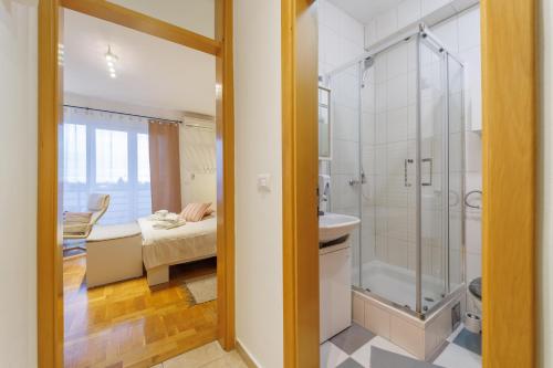 a bathroom with a shower and a sink at Studio apartman The SPOT in Osijek