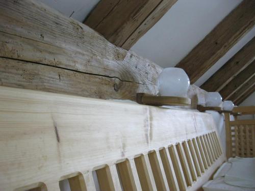 a room with a wooden wall with a radiator at Helles Landhaus auf Waldlichtung in Dießen am Ammersee