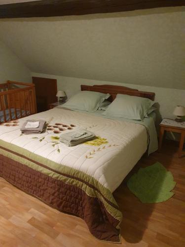 a bedroom with a large bed with medicines on it at Gîte des Hirondelles in Issenheim