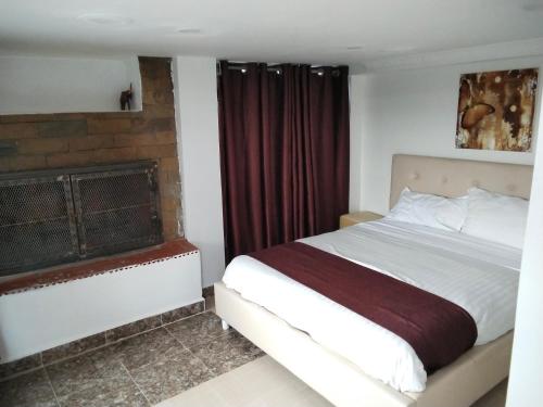 a bedroom with a bed and a fireplace at Tampa holiday home in Naro Moru