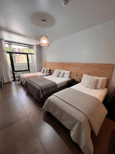 a bedroom with three beds in a room at 5411 Soho Hotel in Buenos Aires