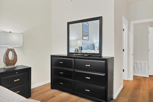a black dresser with a mirror on top of it at Victory Villa - Lux Townhome Walk 2 Globe Life - Rangers & Cowboys Stadiums in Arlington