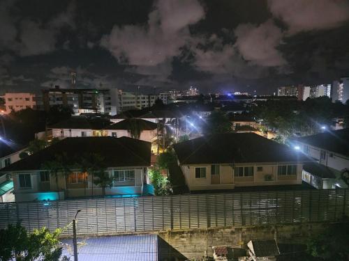a view of a city at night with lights at forest by Bangboon by Parisa in Sathani Wat Sing