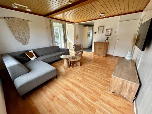 a living room with a couch and a table at Buurman aan zee in Julianadorp