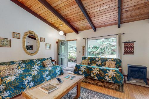 a living room with a couch and a table at Ekomomai Retreat in Volcano