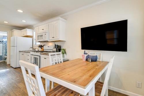a kitchen with a wooden table and a refrigerator at Less Than 1 Mi to Lake Norman Marina Home with Pool Access in Terrell