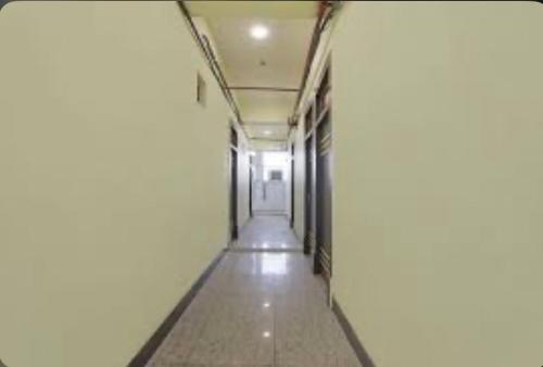 an empty hallway of a building with a hallway at Hotel Mannu Grand in Kānpur