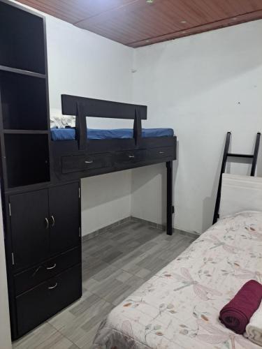 a bedroom with a bunk bed and a black dresser at Apartamento en La Colina in Macanal