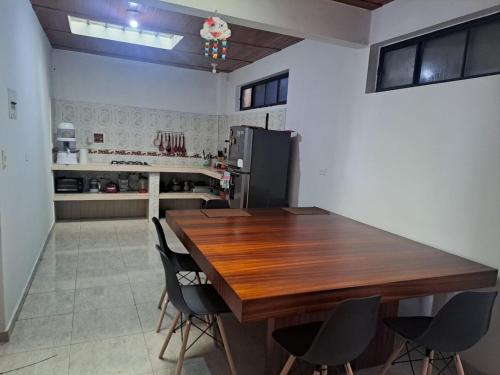 a kitchen with a wooden table and chairs at Apartamento en La Colina in Macanal