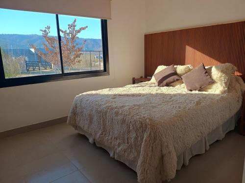 a bedroom with a bed and a large window at Los 4 Vientos, Casa del Valle in San Javier