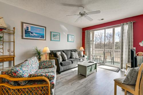 a living room with a couch and a table at 4 Mi to Ocean Myrtle Beach Condo with Resort Perks in Myrtle Beach