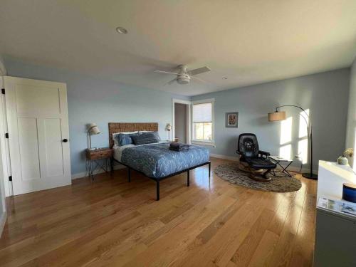 a bedroom with a bed and a chair in a room at Peaceful Oasis by the Great Salt Bay 3BR 2Ba in Newcastle