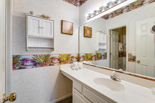 a bathroom with a sink and a mirror at 4 Mi to Ocean Myrtle Beach Condo with Resort Perks in Myrtle Beach
