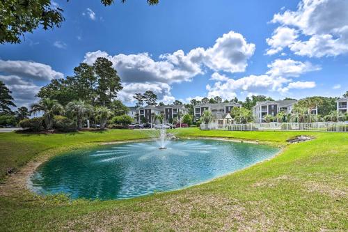 a fountain in a park in front of condos at 4 Mi to Ocean Myrtle Beach Condo with Resort Perks in Myrtle Beach
