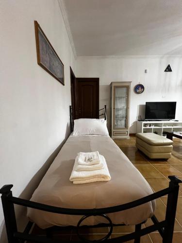 a bedroom with a bed and a living room at LA MAISON aeroporto ciampino in Ciampino