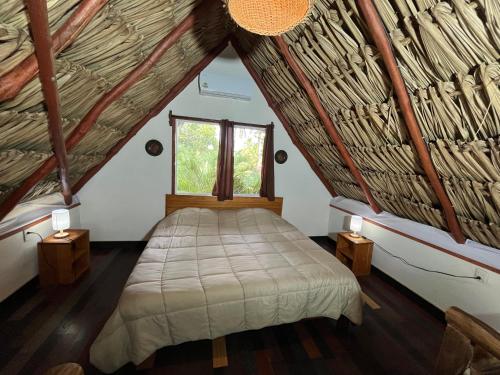 a bed in a room with a window at Embajada Universal By La Eufemia Group in Huay Pix