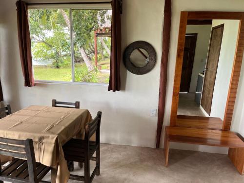 a dining room with a table and a window at Embajada Universal By La Eufemia Group in Huay Pix