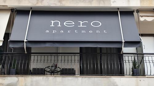 a sign for a neco experience on a store window at Nero Apartment in Agrinion