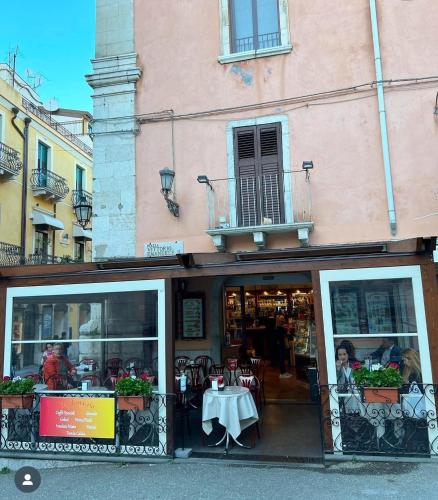 a restaurant with a table in front of a building at B&B Elegance in Taormina
