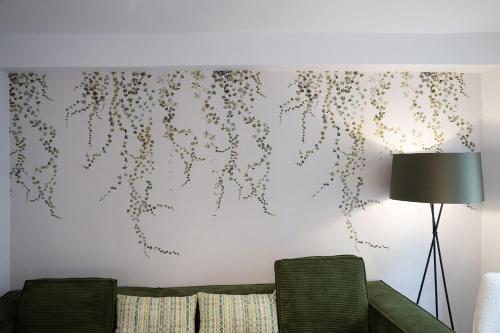 a living room with a couch and a wall at Earra - Goxo - centro, 450m playa in Zarautz